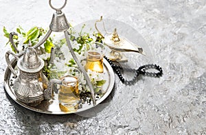Tea glasses, oriental silver tableware, arabian lantern and rosa