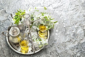 Tea glasses and pot. Oriental silver tableware with decorations