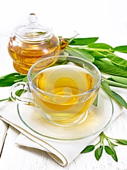 Tea herbal with sage in cup on wooden board