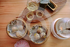 Tea house cafe. Top angle flat lay view of Chinese tea appreciation set and dim sum in bamboo baskets. Elegant glasses and glass