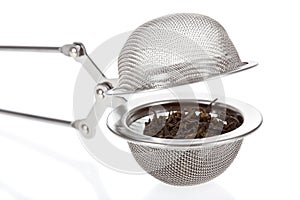 Tea infuser with Green Tea leaves photo