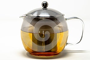 A tea infusing tea pot brewing a cup of tea