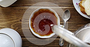 Tea from the kettle slowly pour into porcelain cup