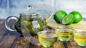 The tea leaves are brew in boiling water and infuse in a small teapot. The concept of the tea party. Green tea in a photo