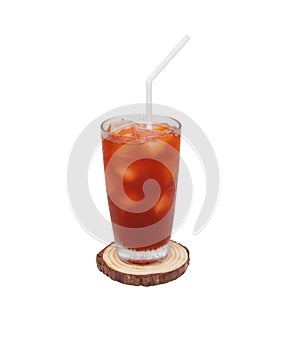 Tea lemon cocktail cola with ice on tall glass on small brown chopping board with white drinking straw.