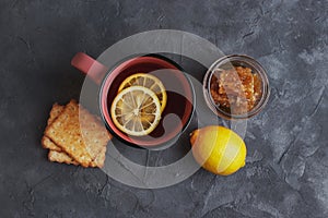 Tea with lemon, honey and grain biscuits. Traditional folk remedy for colds