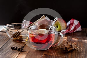 Tea with lemon inside on table