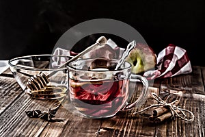 Tea with lemon inside on wooden table