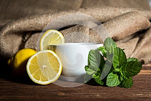 Tea with lemon and mint on wooden table