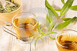 Tea with lemon verbena - Aloysia citrodora. Wood background