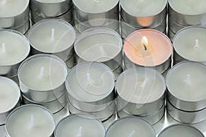 Tea lights candle with one being lit