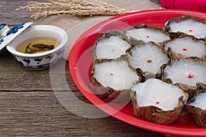 Tea and Many Nian Gao or sticky rice cake on wooden background Chinese New Year`s concept