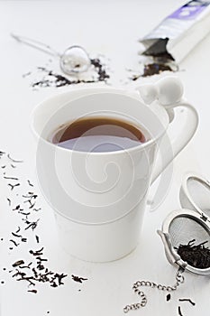 Tea with milk in cracked white porcelain cup with cat