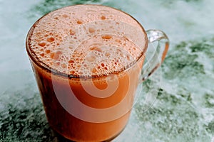 Tea with milk in a mug or popularly known as Teh Tarik.