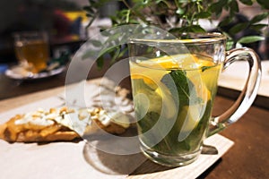 Tea with mint and lemon. Glass cup.