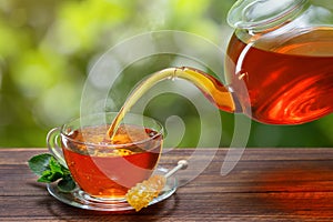 tea with mint pouring from teapot into cup