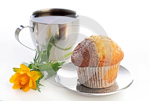 Tea with muffin and a globeflower