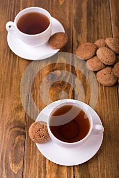 Tea and oaten cookies on a wooden table