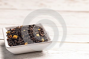 Tea with orange in square plate