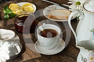 Tea party. Porcelain tea set on wooden table.