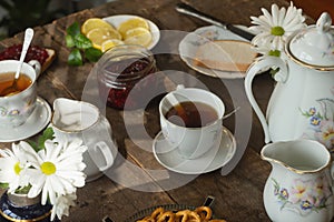 Tea party. Porcelain tea set on wooden table.