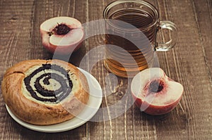 Tea with a peach and pastries/tea with a peach and pastries on a