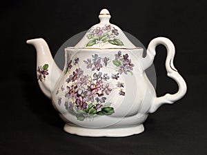 Tea pot on black background