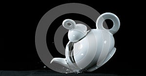 Tea-Pot falling and exploding on Black Background