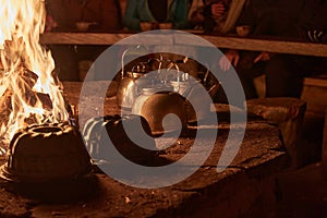 Tea pots by the fire in a hut