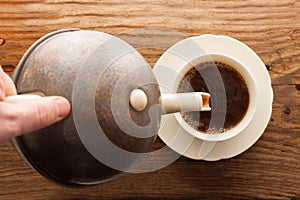Tea pour cup pot wooden table