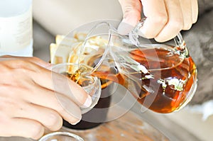 Tea pouring into glass cup