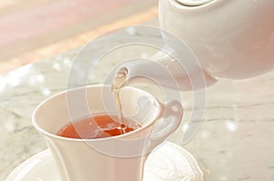 Tea pouring into glass tea cup