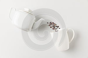 composition of tea pouring from pot into cup