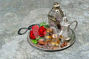 Tea and red rose flower, arabian lantern and rosary. Islamic holidays