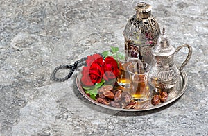 Tea and red rose flower, arabian lantern and rosary. Islamic holidays. Ramadan