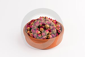 Tea rose buds in a clay pot isolated on white