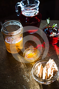 Tea with rosemary, pineapple jam and cookies closeup