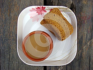Tea and rusk in white plate
