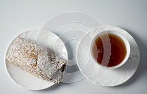 Tea on a saucer with sweet pastries