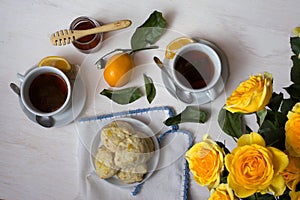 Tea and Scones with Yellow Roses on White Background