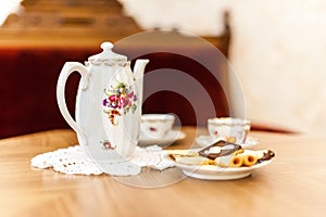 Tea set with bisquits on wooden table