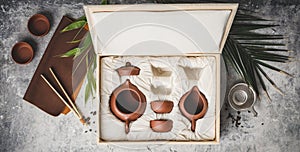 Tea set in the box on concrete background