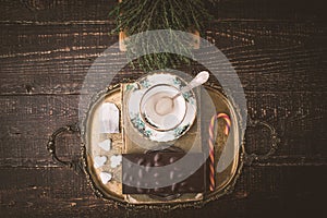 Tea set with herb and chocolate on the wooden table top view