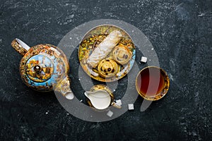 Tea set. Oriental sweets bakery. Top view. Dark background