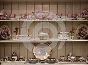 Tea set on white wooden cupboard