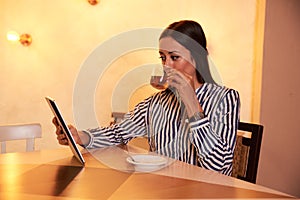 Tea sipping lady with a tablet