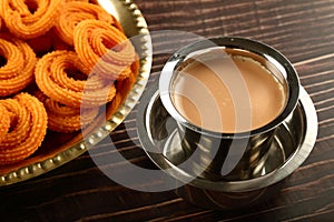 Tea and snacks- murukku or chakli. served in brass plate.