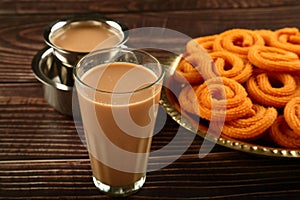 Tea and snacks- murukku or chakli. served in brass plate.