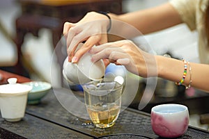 A tea sommelier is making tea for a customer
