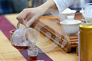 A tea sommelier is making tea for a customer